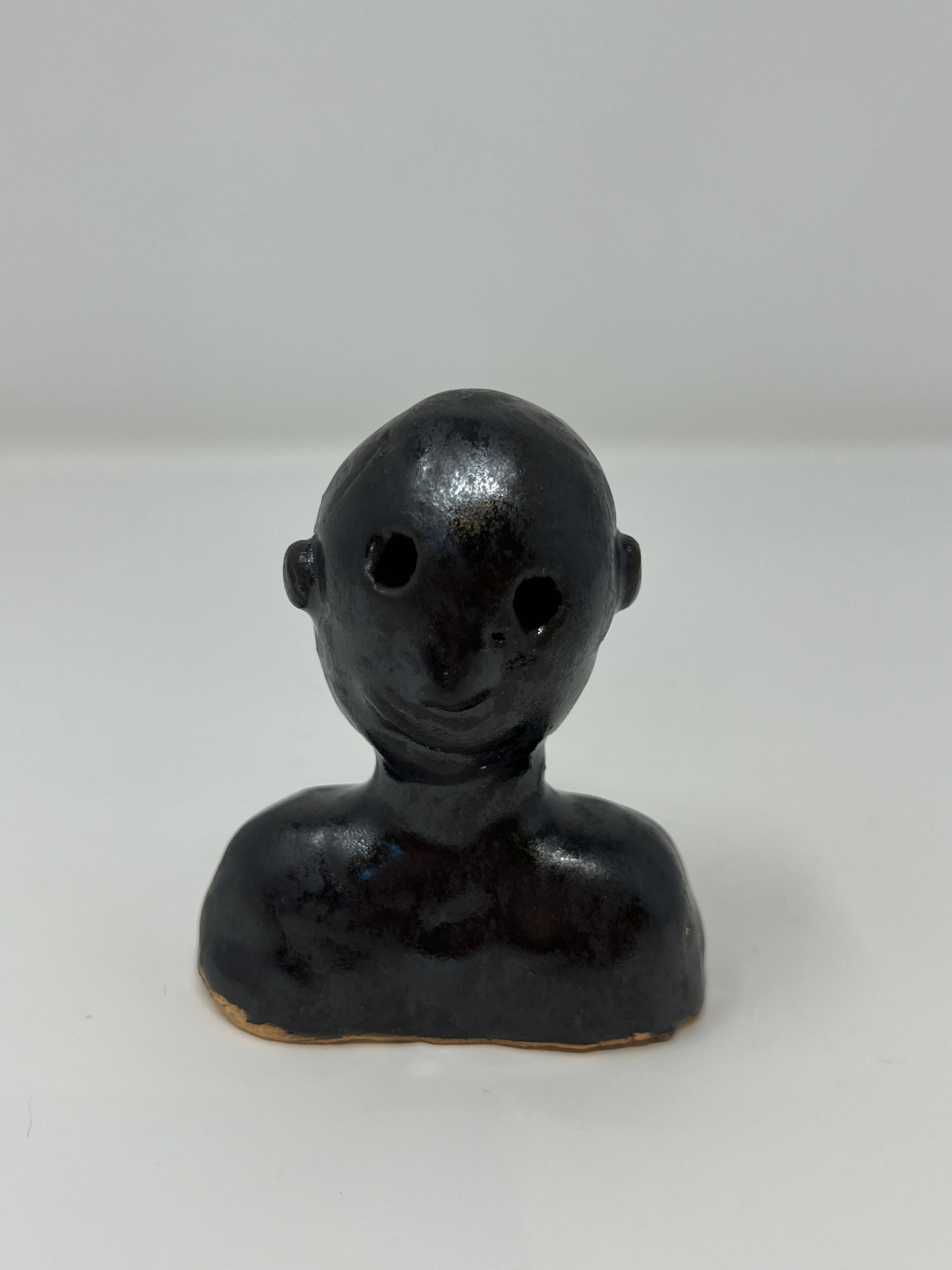 Small male sculpture from shoulder to top of head in black