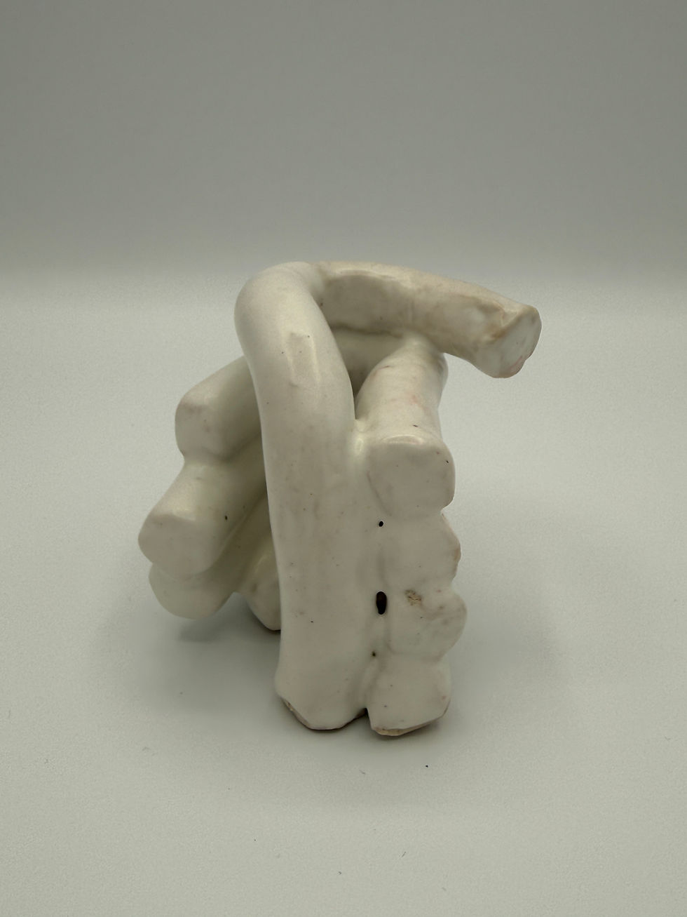 5 attached coils representing closed hand in white