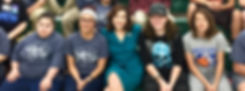 Joy Hofmeister sitting with students.