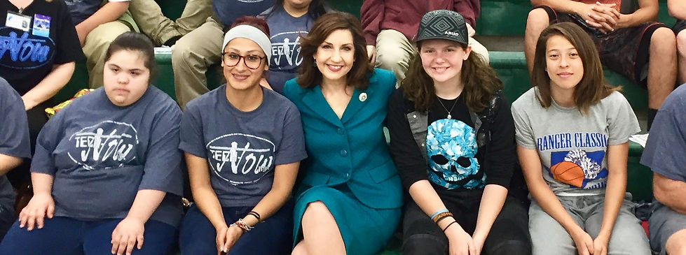 Joy Hofmeister sitting with students.