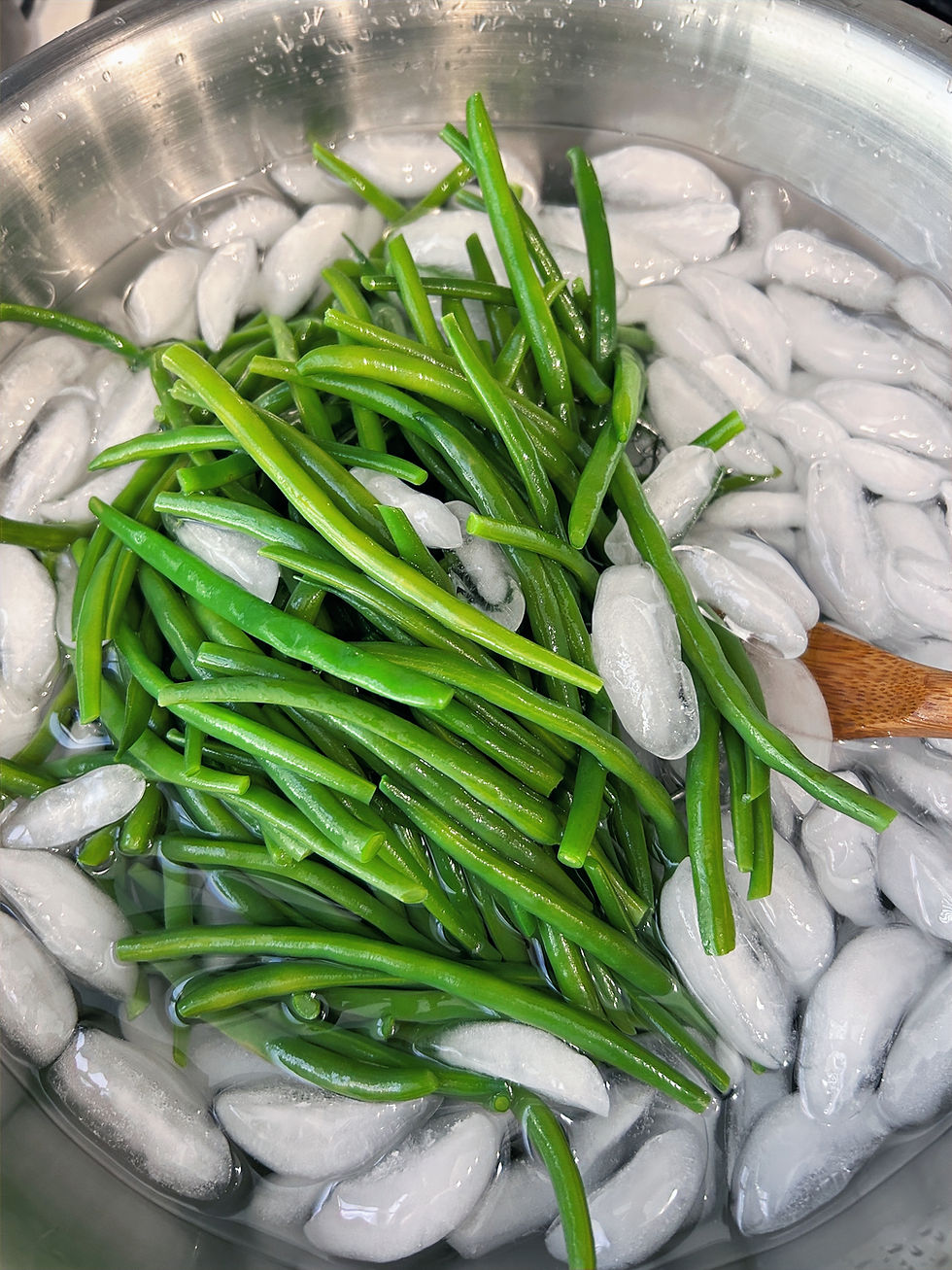Shocking the beans in an ice bath after cooking preserves the color and texture of the beans.