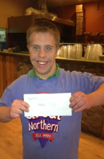 Jared smiling and holding a certificate, representing success and inclusion through project based learning ideas for students with disabilities.