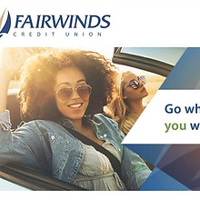 Image of two young women riding in a convertible at sunset. 