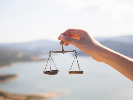 balance scale with sea behind