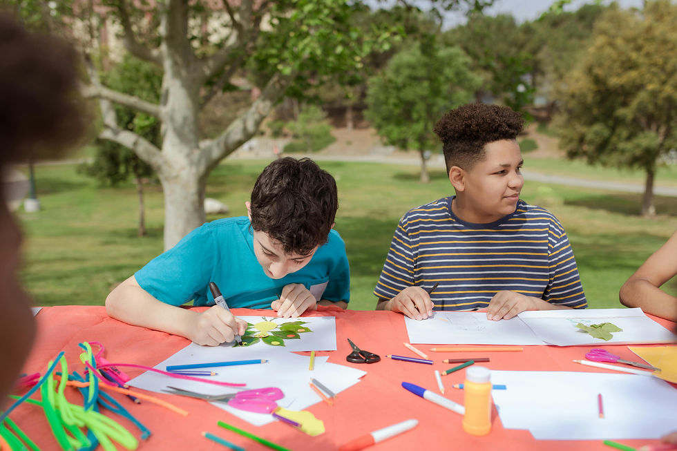 Group of children coloring in natural setting.