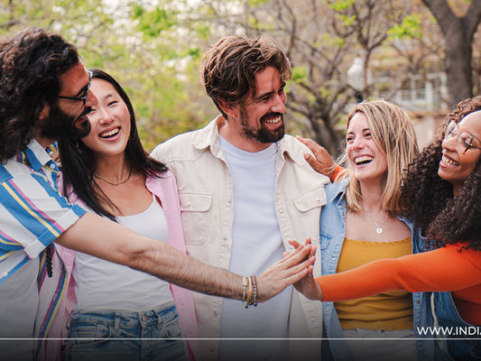 A Group of friends smiling, surrounded by nature—symbolizing how Transcendental Meditation fosters calm, empathy, and deeper connection in friendships.