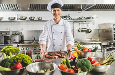 smiling-chef-taking-tray-with-raw-meat-at-restaura-2024-11-19-09-02-05-utc.jpg