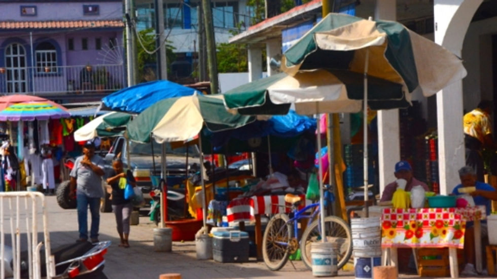 Street filled with umbrellas on the side.