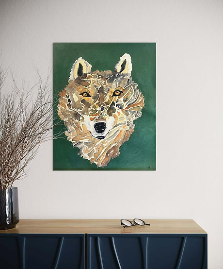 Stylized wolf portrait created with layered collage-like textures in warm browns and greys against a deep green background on the wall.