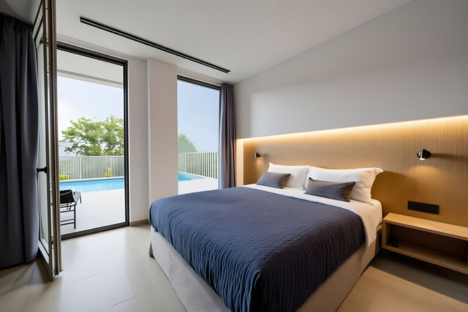 Bedroom of a modern minimal villa airbnb with a swimming pool by 9901 Architects.