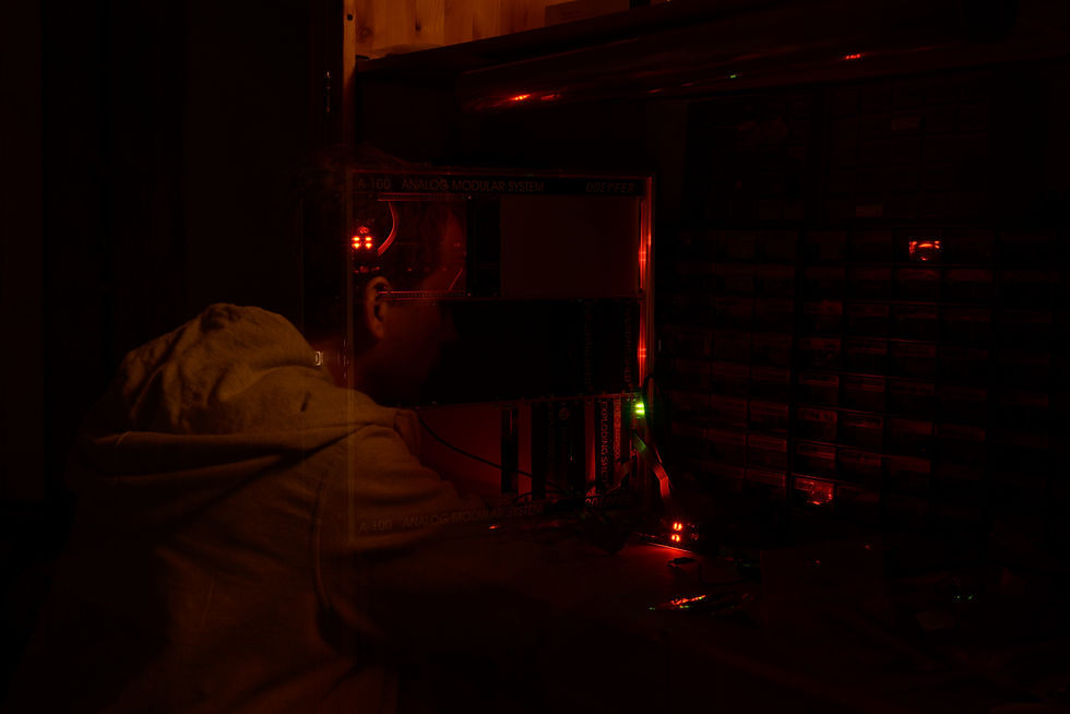 Person in a dark room with red computer lights