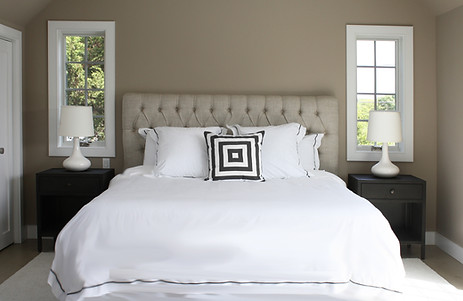 Interior Design Bedrooms, Bedroom Design, Interior Design Amagansett, Best Decorators Hamptons NY, Upholstered headboard, beige headboard, brown walls, brown pait, casement windows, white linens, nightstands, metal nightstands, dark gray nightstands, white rug,