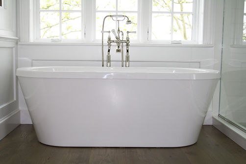 Traditional bathroom, white bathtub, freestanding bathtub, wood bathroom floors, tub filler,