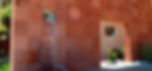 Water fountain on red tile wall