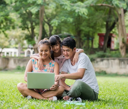 happy-family-father-mother-daughter-sitting-grass-playing-laptop-outdoor-park_edited.jpg