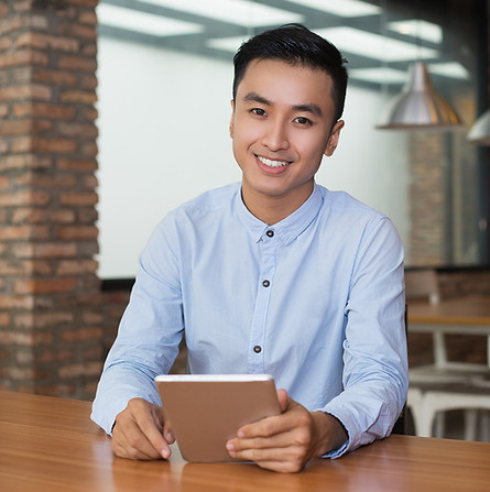 smiling-man-sitting-cafe-table-with-tablet.jpg