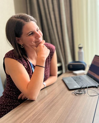 Podcast host Anna Ciriani-Dean reflects on her ESL pedagogy next to a computer.