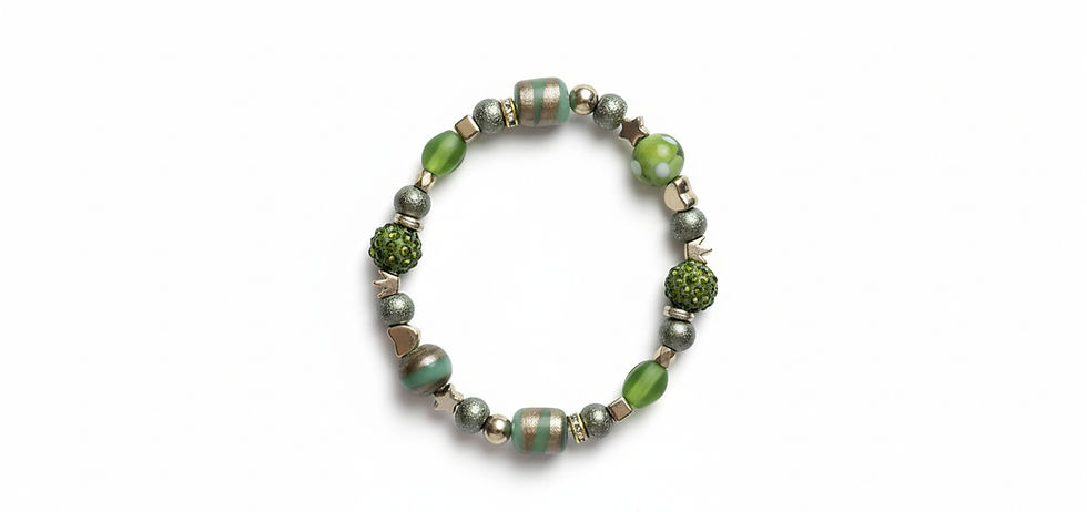 An artisan-style stretch bracelet with a variety of green glass beads, including polka-dotted and gold-striped designs, accented with sparkling green pavé crystal beads and textured metallic spacers on a white background.