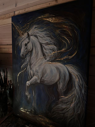 Painting of a unicorn with gold leaf detailing in dusk light.
