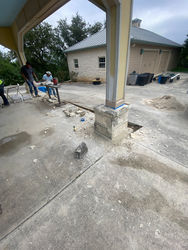 Renovated pavilion with columns wrapped in metal and covered with stone, replacing old rotten wood posts. 