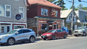 busy stree view in Greenville, Maine of Jameson's Store home to the best Dagwood Sandwich!