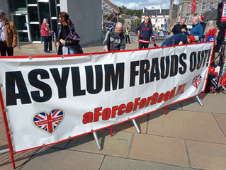 Banner saying "Asylum Frauds Out" at AFFG's rally on 6-9-25