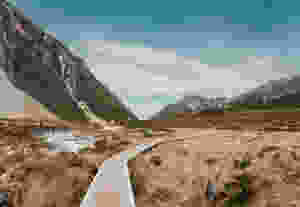 Man walking in New Zealand wilderness, journey.