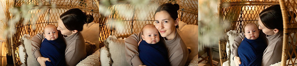 Mother cradles a baby in a blue wrap, seated in a wicker chair with beige cushions. Warm lighting; cozy and tender atmosphere as photographed by Tiffany Edwards, Newborn and Childhood Photographer in Billings Montana