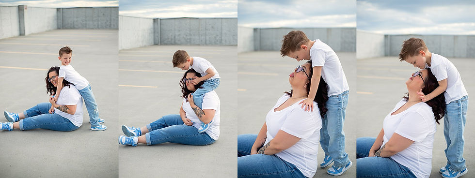 Woman sitting, smiling with a boy hugging her from behind in an empty parking lot on the top story of a parking garage. Both in white shirts and blue jeans. Playful mood as photographed by Tiffany Edwards, Newborn Photographer in Billings, Montana.