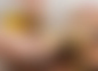 A person pouring olive oil onto a piece of bread