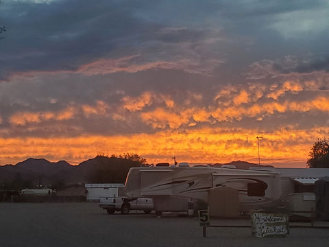Arizona desert sunset over Split Rail RV Park with wide open skies and RV sites