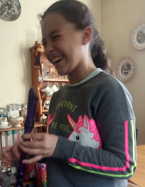 child laughing holding a recorder