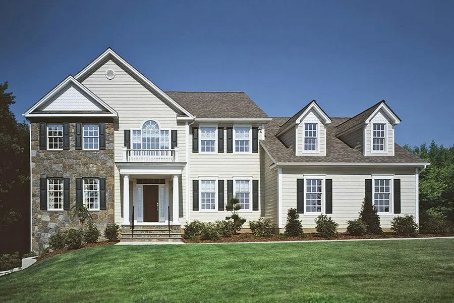 High-end luxury custom modular residence with premium siding and stone facade details.