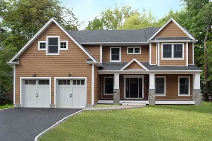 Contemporary custom modular home with cedar-style siding and double garage bays.