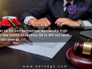 A legal-themed banner from adrEdge featuring a professional desk setup where a person holds a fountain pen to sign a document. A wooden judge's gavel rests on its block in the foreground next to a laptop, while a golden scale of justice and a red coffee cup sit in the background. Overlay text reads: "No power to fix compensation: Karnataka high court on the limits of section 34 in NH act land acquisition awards." The adrEdge logo is visible in the top right, with the website URL www.adredge.com at the bottom.