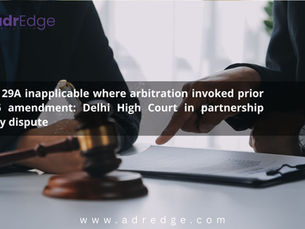 A wooden gavel on a desk with two individuals in suits pointing to a legal document in the background, featuring text regarding the Delhi High Court's ruling on Section 29A and partnership property disputes.