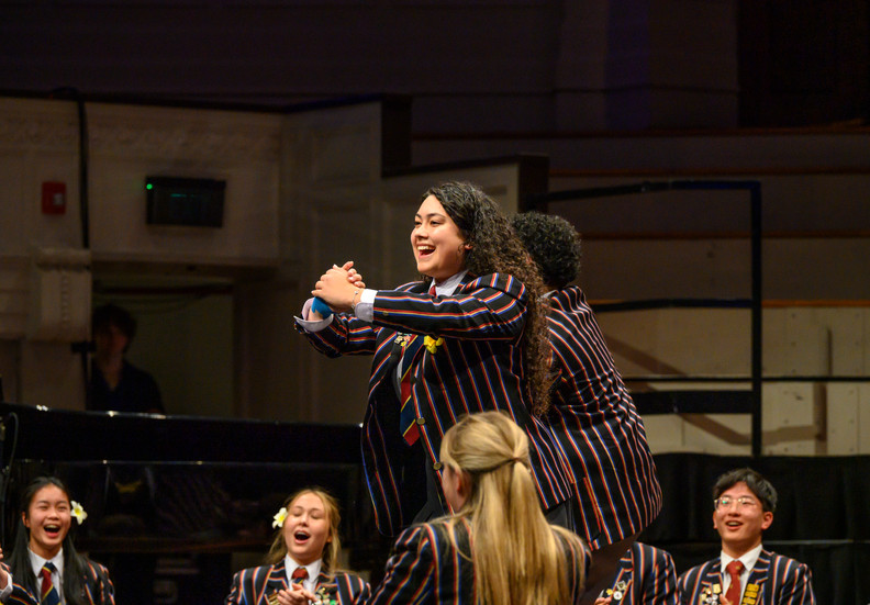 Young female in school uniform performing