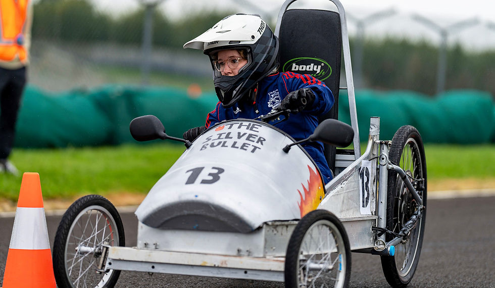 female in a go-kart with helmet and glasses on