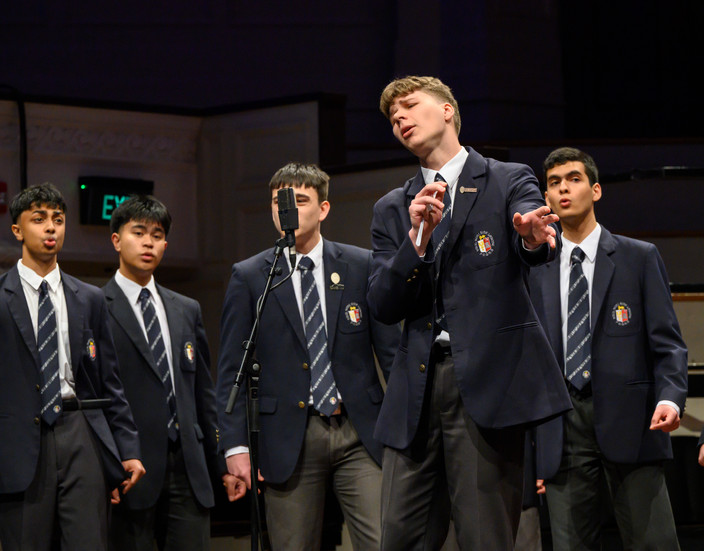 Young Males singing in school uniform