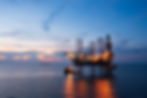 Aerial view of offshore jack up rig and offshore platform during sunset for oil and gas ex