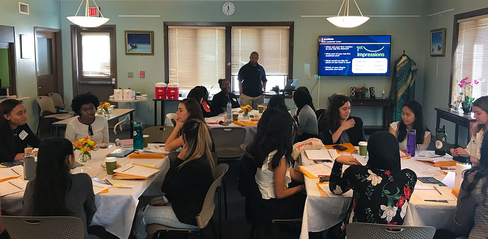 Several groups of women are sitting around tables at a conference. They are women of varying races and ethnicities, and are deeply engaged in their conversations. They look like a new generation of leaders!