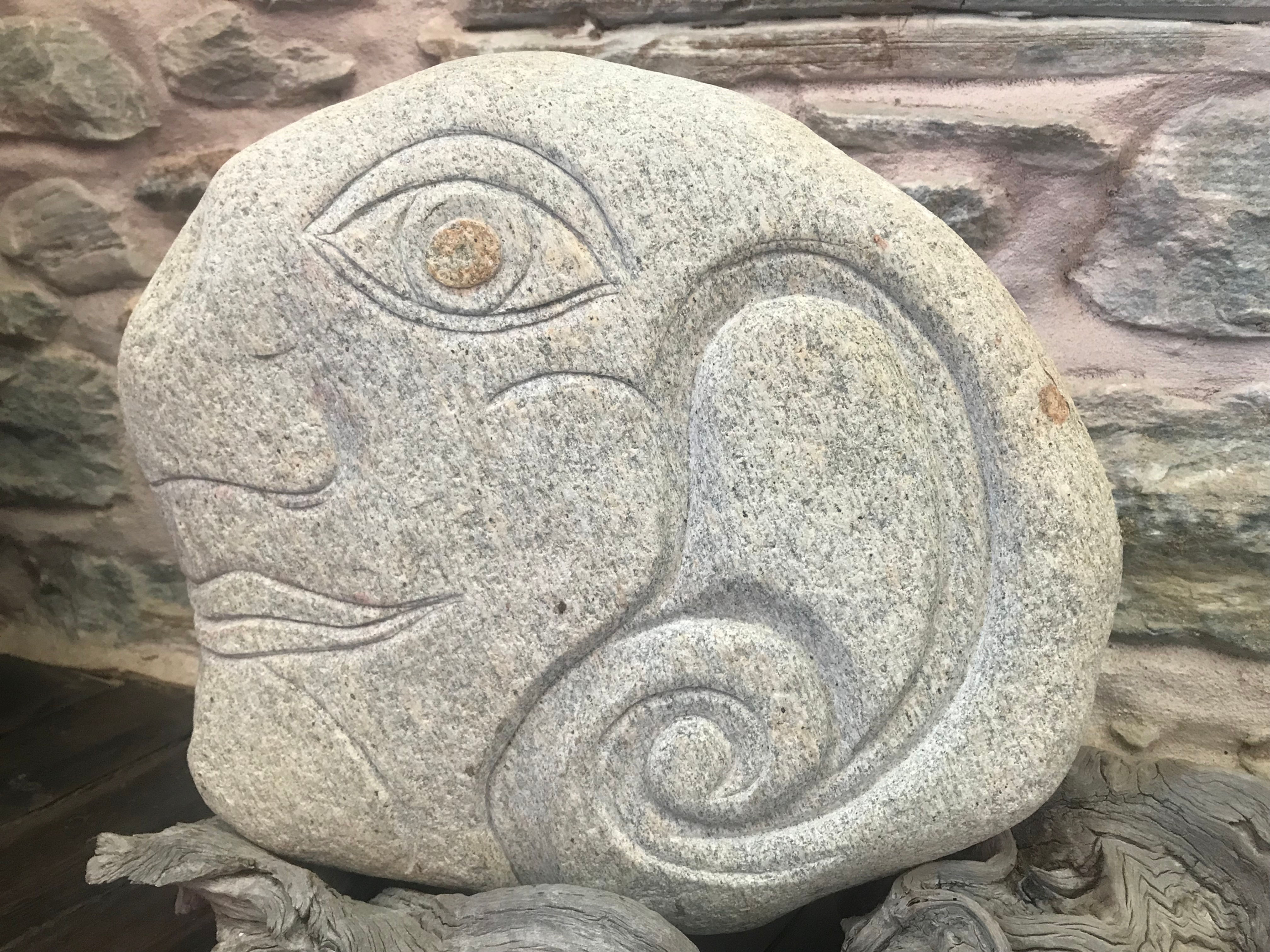 Head carved on stone