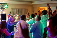Wedding guests dancing and singing at reception at Harbour House. Photo by Pixel Groves