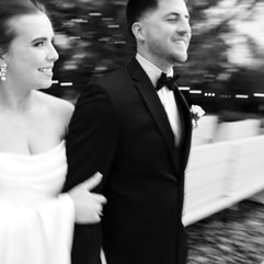Bride and groom walking together in motion during wedding exit moment