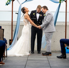 Bride and groom laughing during rooftop ceremony at Hotel Melby in downtown Melbourne, Florida
