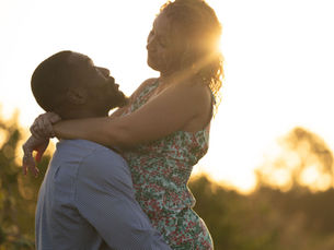 Couple embracing during golden hour engagement session at Ever After Farms Peach in Florida
