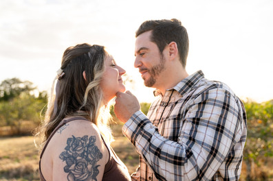 A soft and romantic moment between the parents-to-be during golden hour