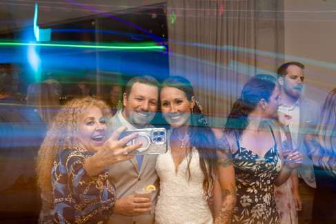 Bride and groom taking a photo during their wedding reception at Hotel Melby in Melbourne, Florida