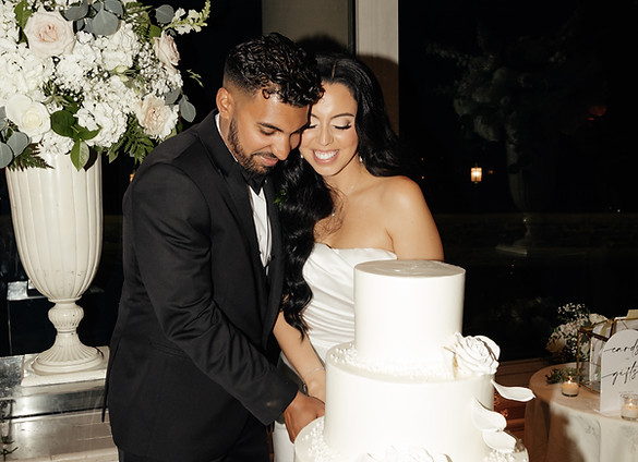 BRIDE AND GROOM CUTTING CAKE.JPG