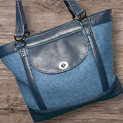 Felicity Tote bag made with blue wool-look and faux leather panels, featuring a front flap pocket and structured handles, sewn using a Bagstock Designs pattern